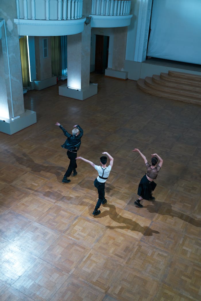 Dancers gracefully performing in a stylish, grand ballroom setting.
